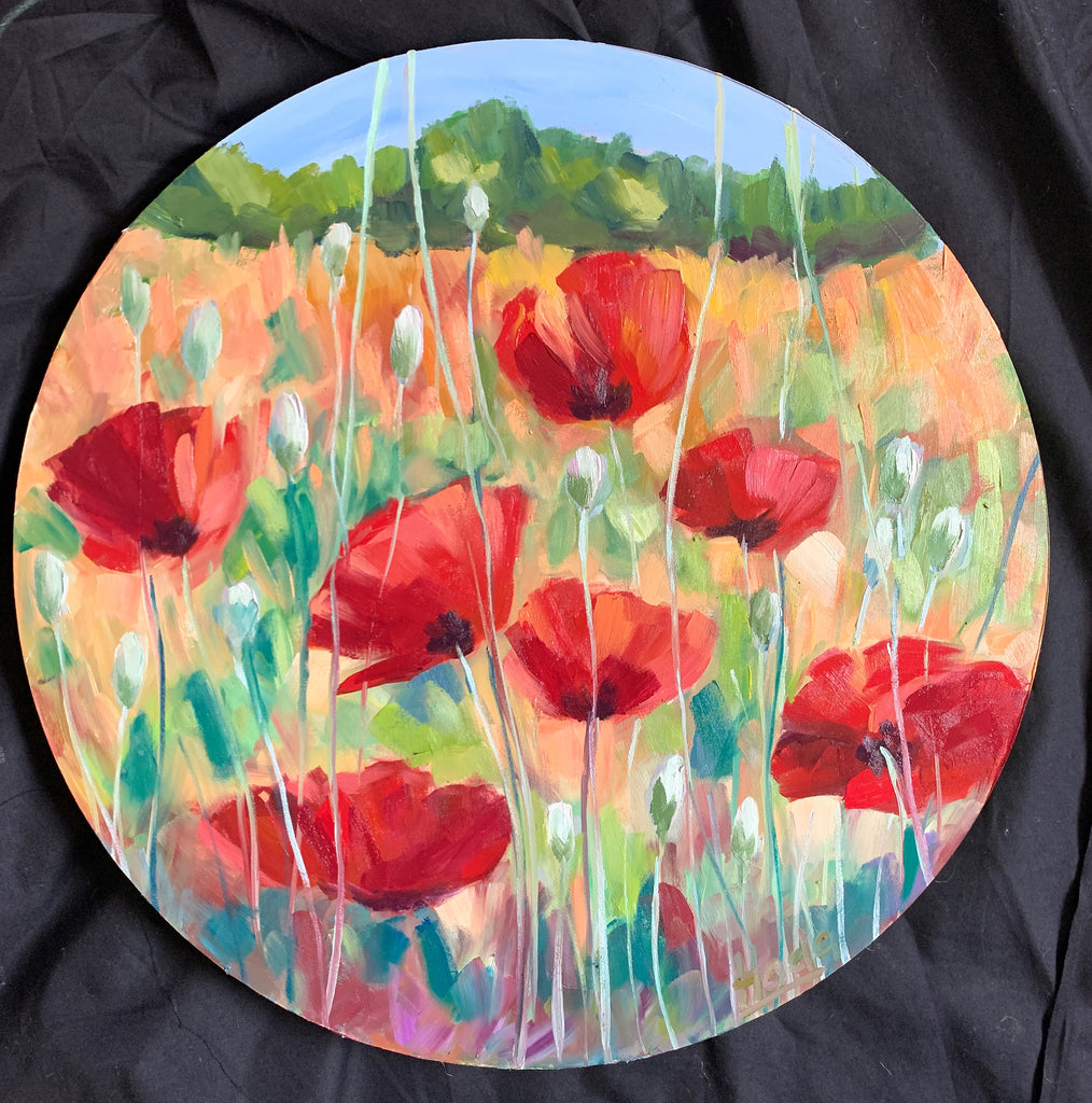a round oil landscape painting on hard wood of red poppies in a field 