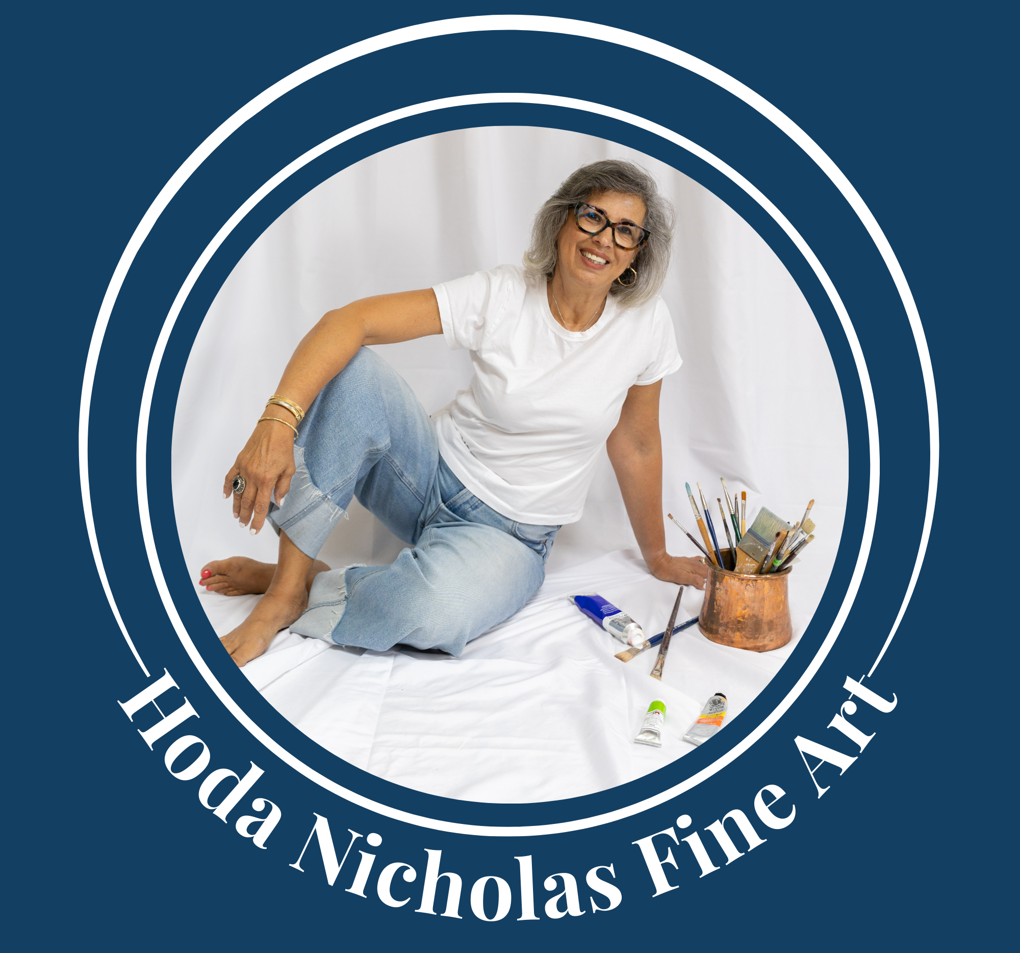 Woman sitting on a white surface with art supplies, surrounded by a circular border with 'Hoda Nicholas Fine Art' text.
